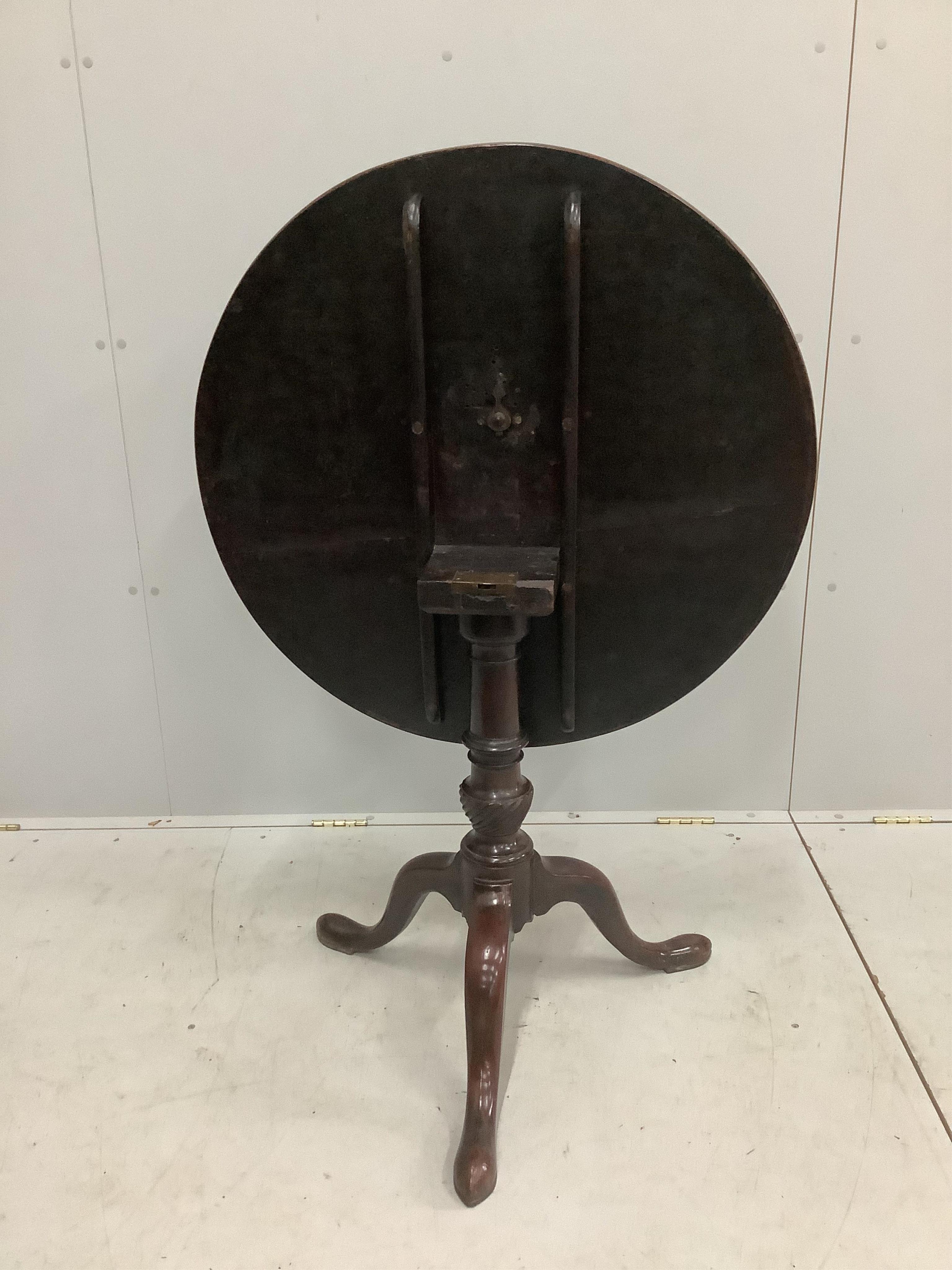 A George III circular mahogany tilt-top tripod tea table, diameter 82cm, height 71cm. Condition - fair